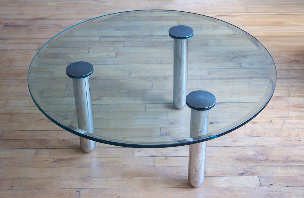 A round glass coffee table with three tubular chrome legs designed by Marco Zanuso for Zanotta, circa 1970.