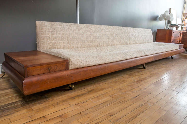 This is a Custom Model 1709-S Sofa that is 12.5' long.  It features solid walnut trim, brass casters, and two side cases with drawers.  The strapping and foam needs to be replaced.  The upholstery is Haitian cotton.  It is in excellent condition and
