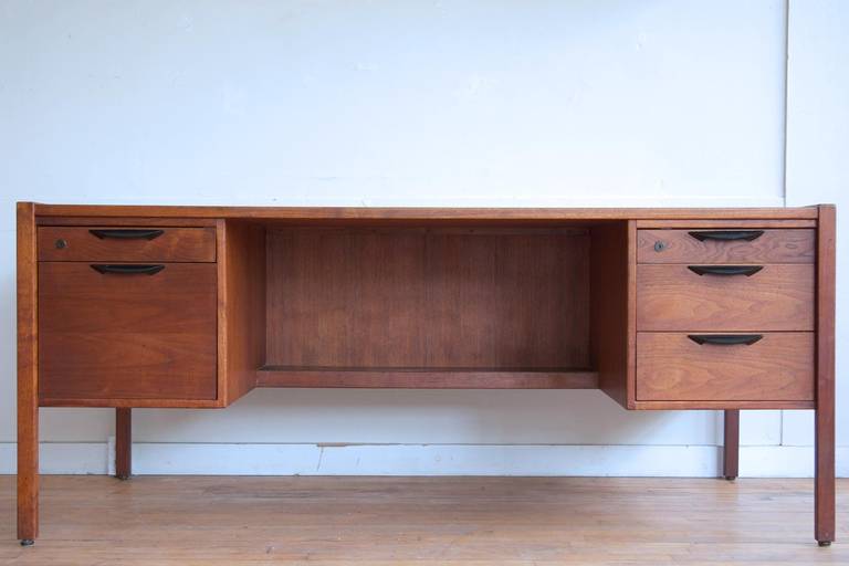 A large walnut executive desk designed by Jens Risom, circa 1960.