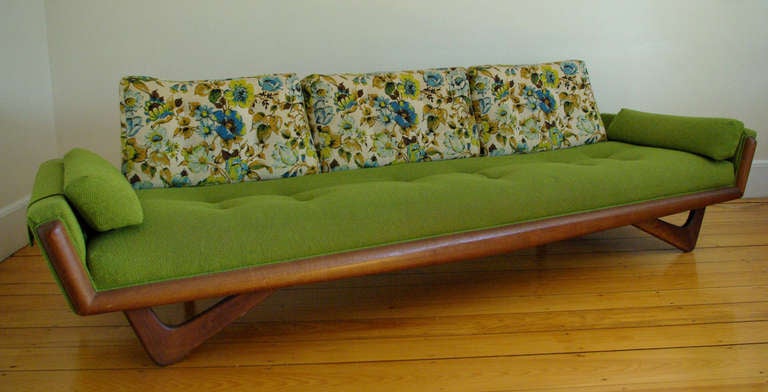 A wonderful Adrian Pearsall three-seater sofa manufactured by Craft Associates with sculptured walnut front rail and boomerang legs. Retains its original floral and green upholstery.

A clean example in very nice condition.