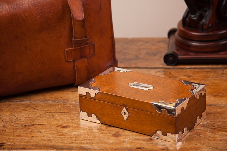 An English oak cigar box with silver mounts and makers mark on interior 'Mappin & Webb' dated London, 1887.