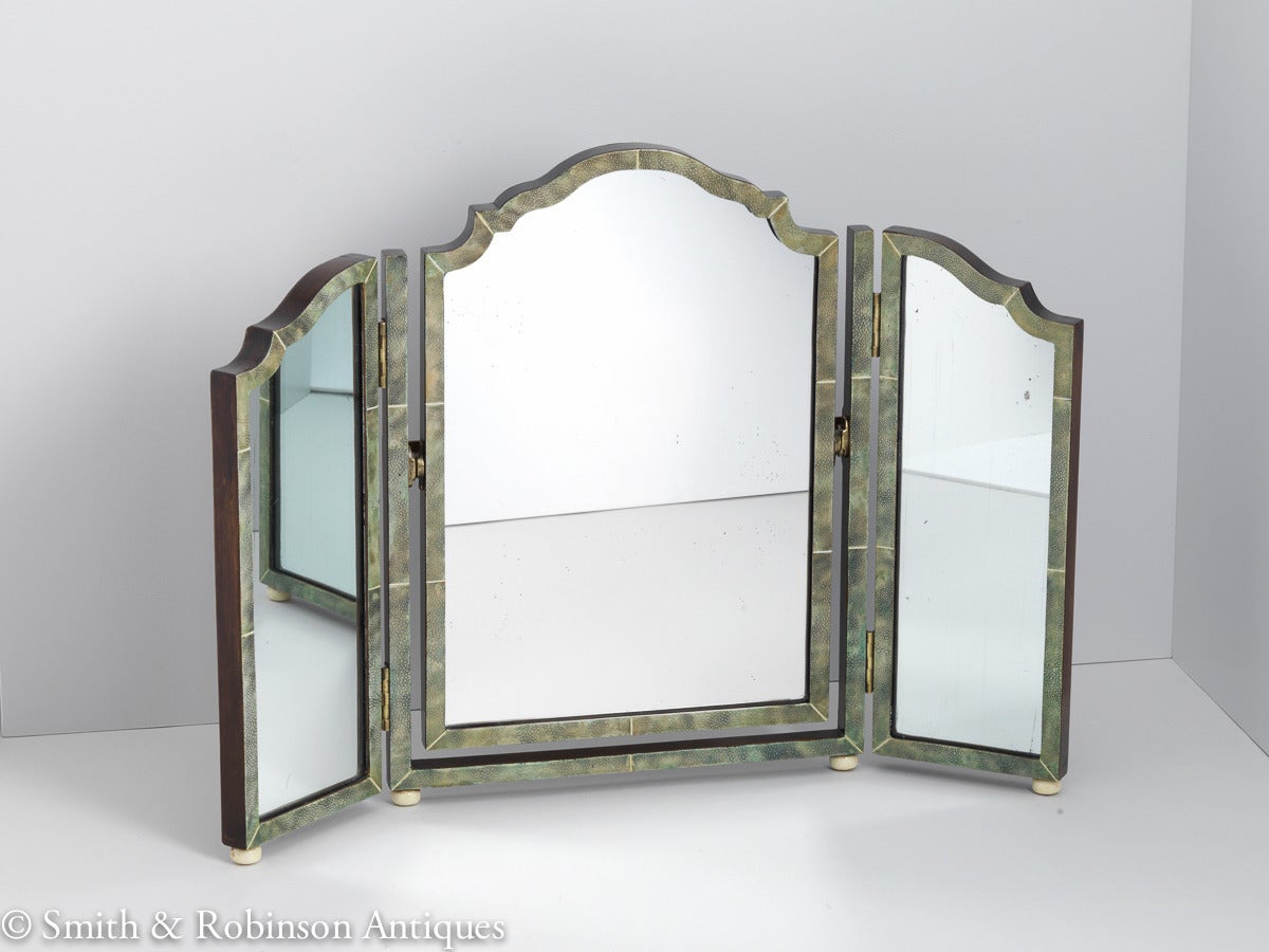 A beautiful Art Deco shagreen three-fold vanity mirror in a lovely muted color and original good condition.

It has its original plate and original back.

We are always adding to our 1stdibs catalogue so be sure to add us to your favorite