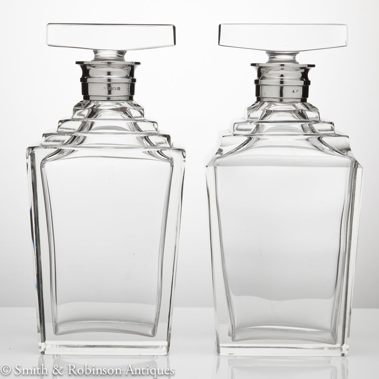 A exquisite pair of fine Art Deco decanters with silver collars dated Birmingham 1938 by makers Asprey & Co.