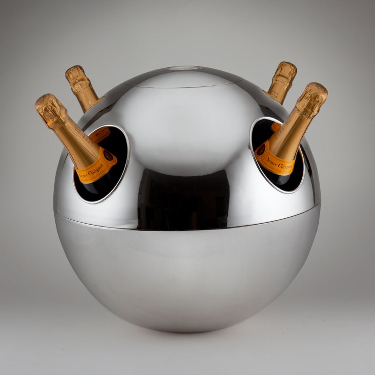 A large & impressive spherical champagne cooler by Teghini , Firenze , Italy c.1970
The top lid reveals an original ice bucket container and whereby it can also be used by loading the ice directly into the gilded interior.

It really is a fantastic