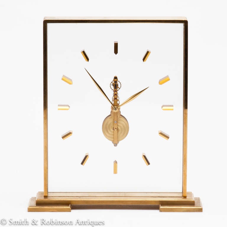 Jaeger-LeCoultre Clock with a slender jewelled movement, Switzerland c.1960 
Stepped base & gilded metal frame, numerals & movement encased within thick clear lucite.