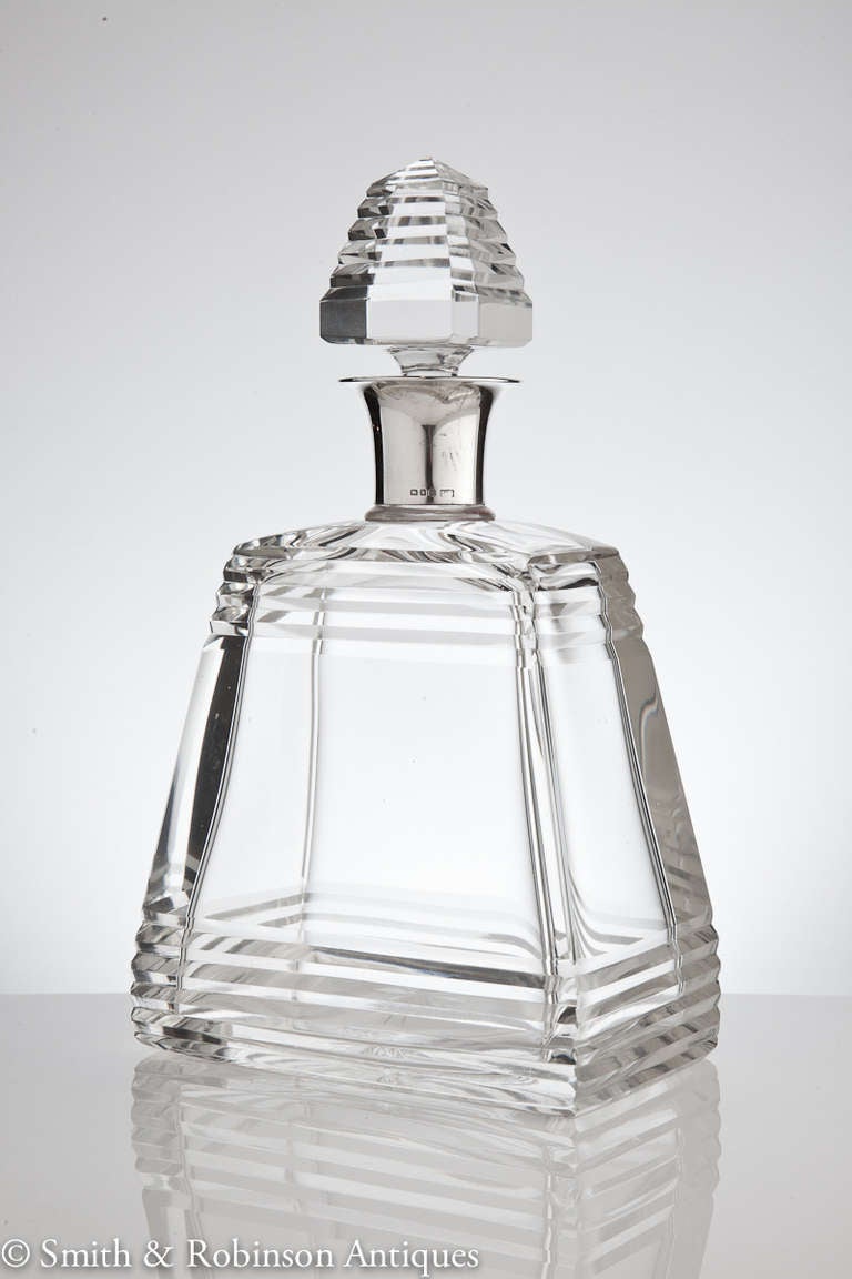 A fine Art Deco pyramid shaped decanter with a deep faceted cut to the body which is repeated in the stepped stopper. The English silver collar is fully hallmarked and dated London, 1930 by makers Mappin & Webb.
We are always adding to our 1stdibs
