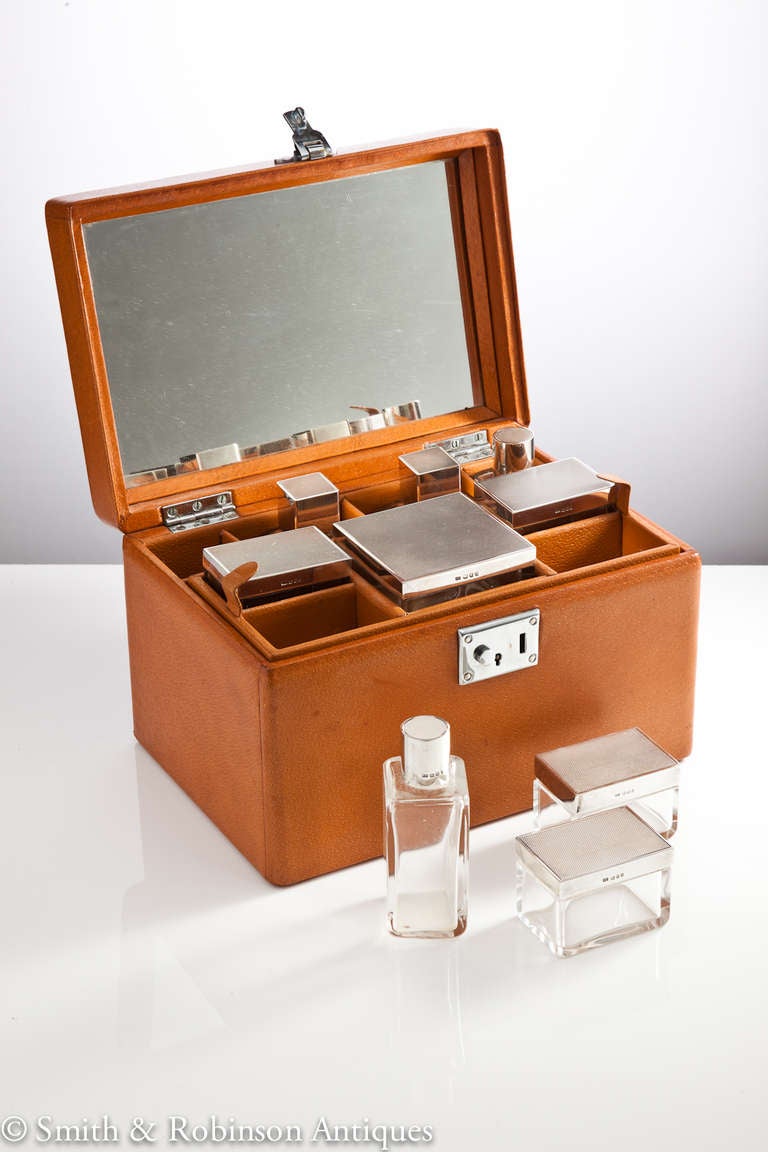 An exquisite Asprey Brothers vintage leather travelling case with all fitted accessories for grooming.
Complete with a full original set of English silver-mounted glass bottles and jars all stamped Asprey and dated London, 1954.
The case itself