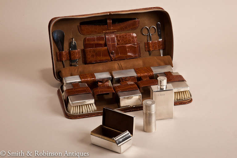 An English Mappin & Webb gents traveling case & grooming set in perfect  unused condition & complete with all original silver accessories. 
All the containers are unused including the brushes, also there are all the grooming accessories which sit