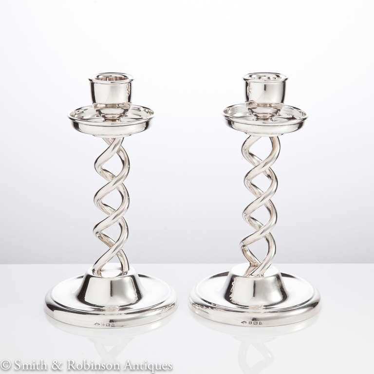 A pair of unusual silver candle sticks with great form & delicately designed barley twisted stems complete with fully hallmarked bases by makers Leon Schlund & dated Birmingham 1905. 

A perfect gift idea.

We are always adding to our 1stdibs