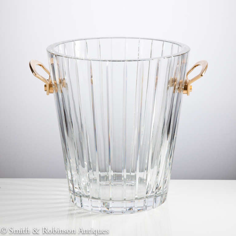 Superb ice bucket by Baccarat of France French c.1960. 
Stunning quality thick clear glass with gilt metal handles.  
Stamped on both the base & also impressed marks on the gilt metal handles.

We are always adding to our 1stdibs catalogue so be