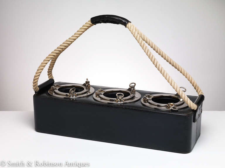 A very unique & useful bottle holder & carrier with a nautical theme ideally for the boat or for the poolside bar.
All stiched leather custom exterior & rope carrying handle with nickel plated  rim portholes which all open for cleaning.
Great look