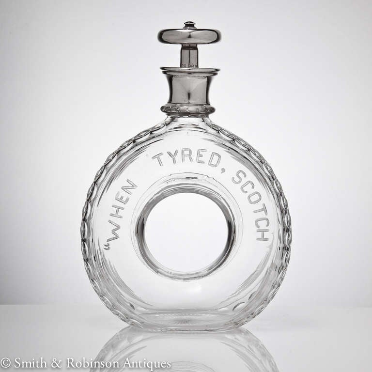 A great novelty scotch tyre shaped decanter with glass body that reads 