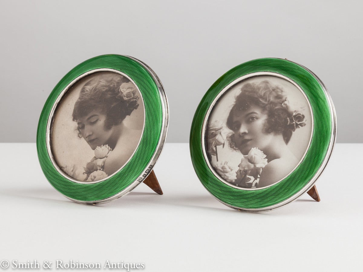 A beautiful pair of Art Deco silver & enamel circular photo frames dated Birmingham 1921 by Makers John Deakin & William Deakin

The enamel is of the finest quality & a rare & vibrant green colour. 
Complete with their original oak backs.