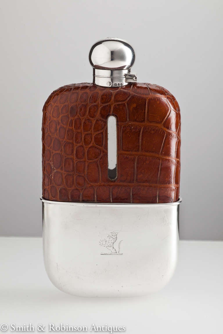 An impressive large silver & crocodile leather hip flask with detachable cup & in unused condition, dated London 1896 by maker Aide Bros Ltd.
The top has a bayonet fitting with cork interior which is air-tight.

A superb gift idea !
 
We are