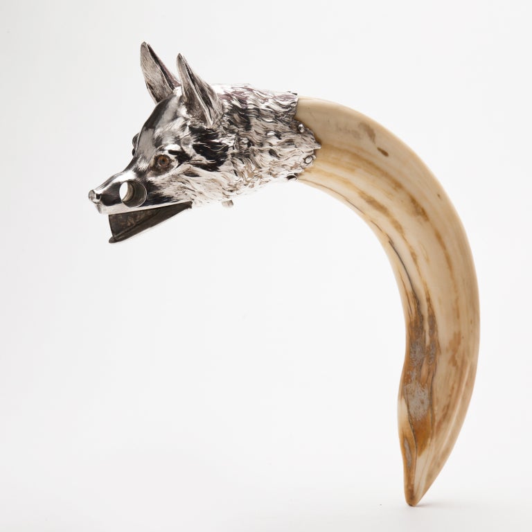A silver mounted cigar cutter in the form of a Foxes Head Mounted on a curved Boars Tusk handle
Austrian circa 1910-15

Shown also with a glass, silver & tusk ash-tray, available in a separate listing.