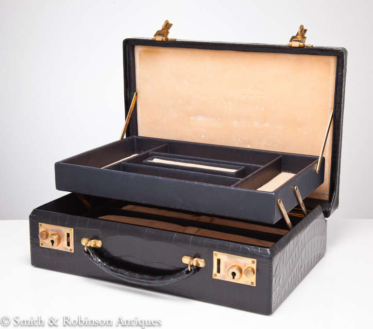 Beautiful quality traveling crocodile jewel box English, circa 1930-1935. The fine and carefully chosen skins have their original sheen. When opened the hinged folding tiers reveal a velvet interior and padded trays. Unused and in excellent