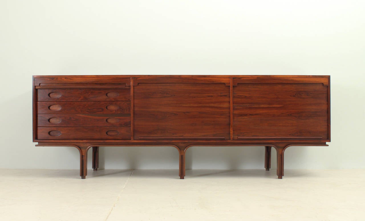 Rosewood sideboard with tambour doors designed in 1957 by Gianfranco Frattini for Bernini, Italy. Four drawers and two spaces with shelves.