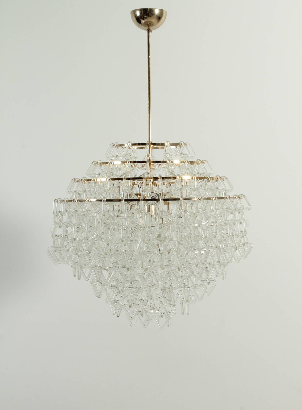 Exceptional Italian chandelier from 1970s, in the manner of Angelo Mangiarotti works. Made of hundreds of Murano glass pieces interlaced with triangular form and brass structure with four lights.