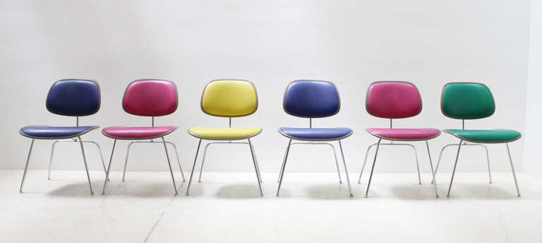 A set of colorful soft DCM chairs designed by Charles and Ray Eames in 1971 for Herman Miller, USA. Oatmilk fiberglass seat and backrest upholstered with the original vinyl, chromed steel bases.