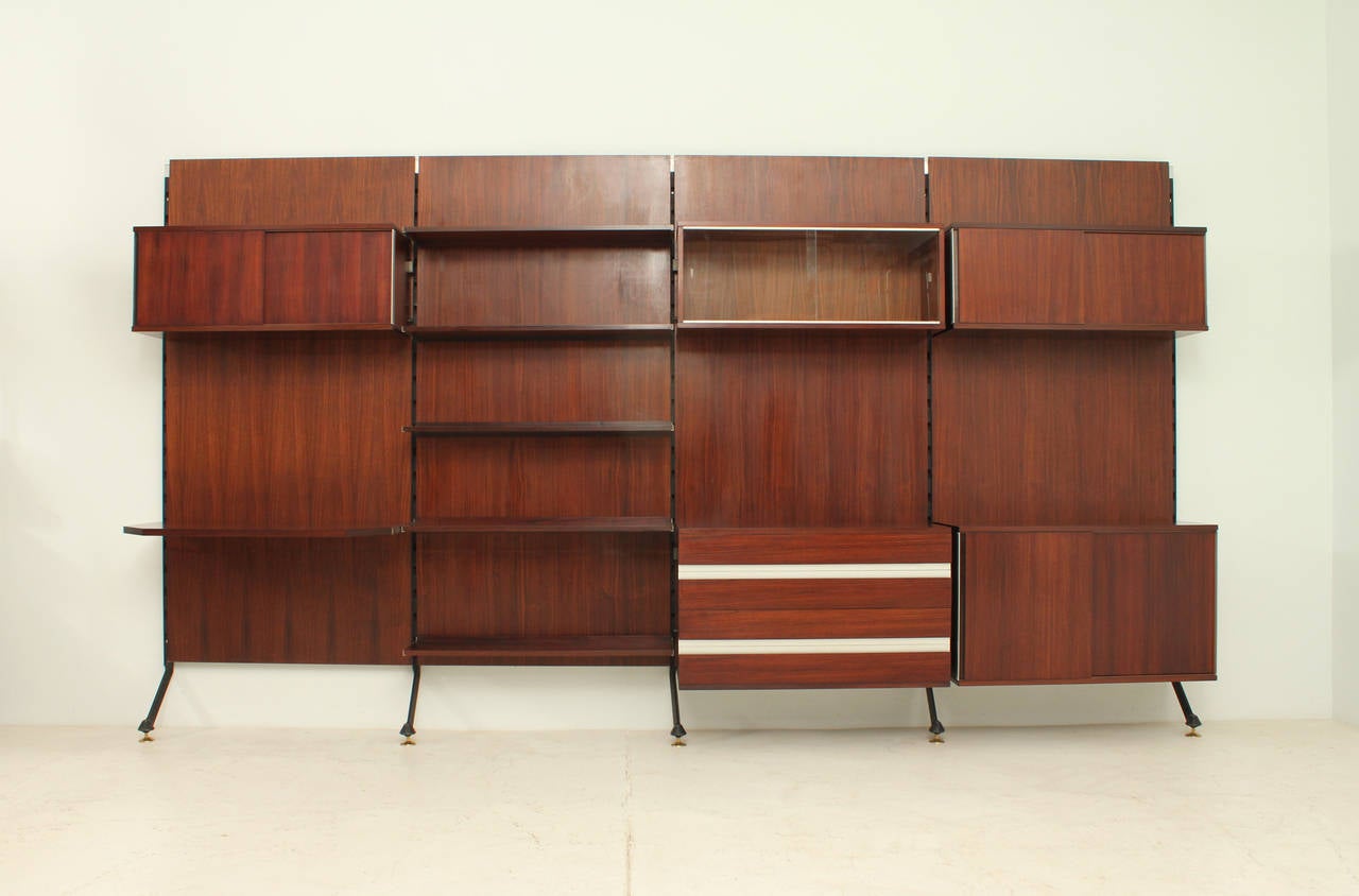 Urio wall system in rosewood designed in 1957 by Ico Parisi for Mim Roma, Italy. Different elements including shelves, desk, chest of drawers and cupboards with sliding doors.