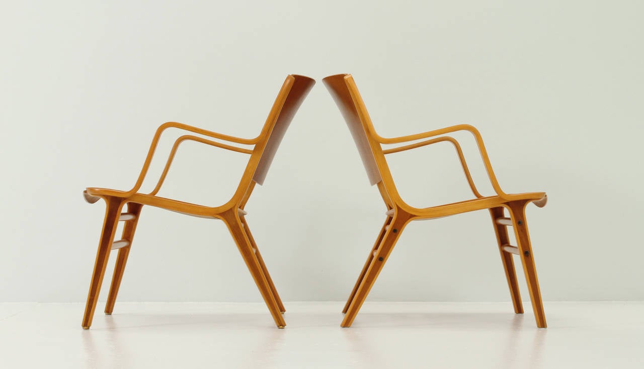 A pair of Ax chairs designed by Danish designers Peter Hvidt and Orla Mølgaard-Nielsen in 1950 for Fritz Hansen, Denmark. Beech and teak plywood.