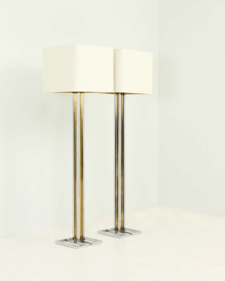A pair of floor lamps from 1970's, Italy. Chrome and brass bases and shades with new fabric.