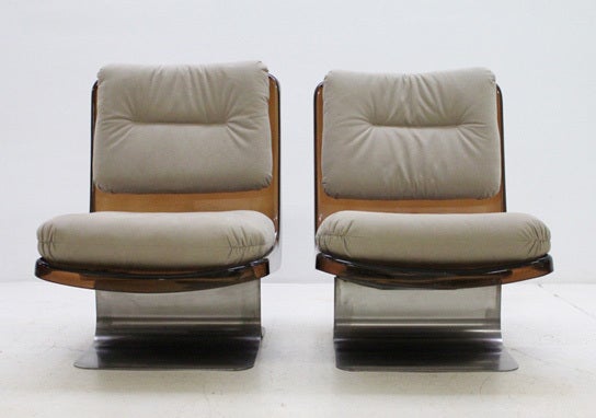A pair of lounge chairs from 1970's produced by Grosfillex, France. Smoked plexiglass shells with cushions covered with new glove fabric from Kvadrat and heavy curved steel bases.