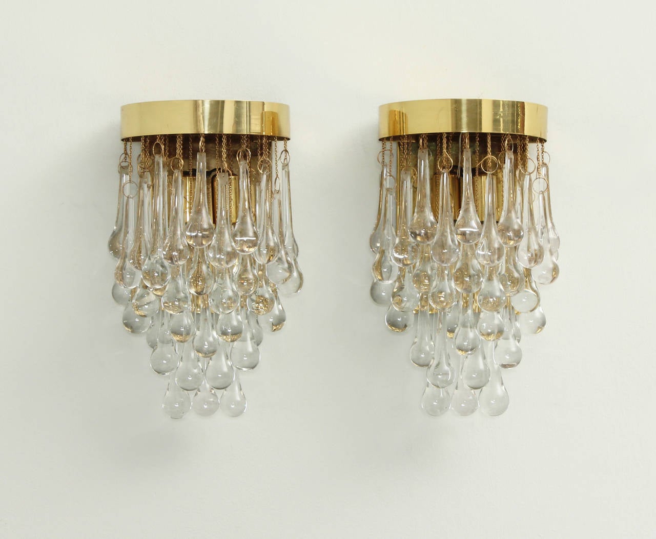 A pair of glass teardrop sconces from 1970's. Italy. Clear glass and brass.