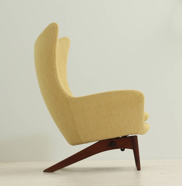 Reclining wing chair designed in 1950's by H. W. Klein, Denmark. Teak base with tilt mechanism and new wool fabric upholstery.