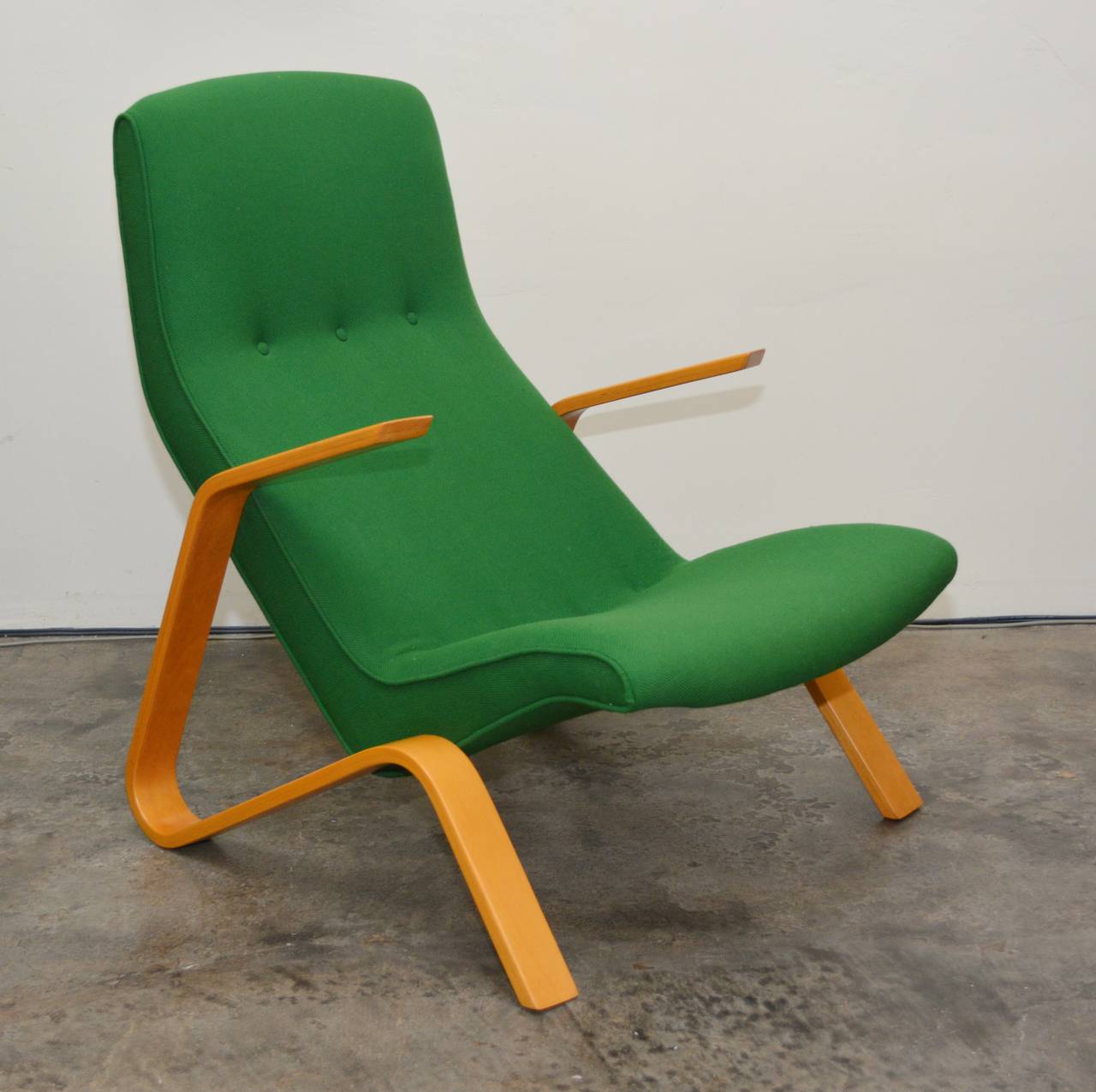 Knoll grasshopper chair designed by Eero Saarinen. This chair has an older restoration. The wood is in good shape and only shows light wear. There is a chip repair on one arm. The hopsack fabric has some snags, a couple of light spots and two small