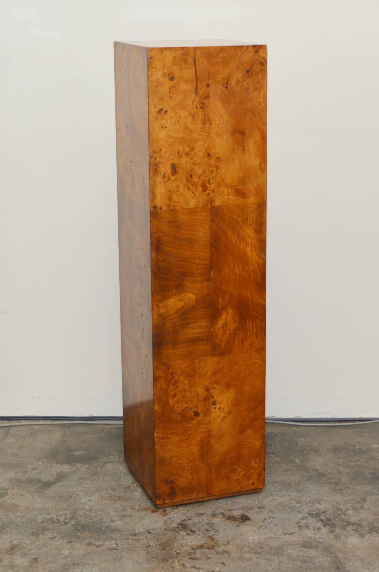 This pedestal has elm burl wood veneer.