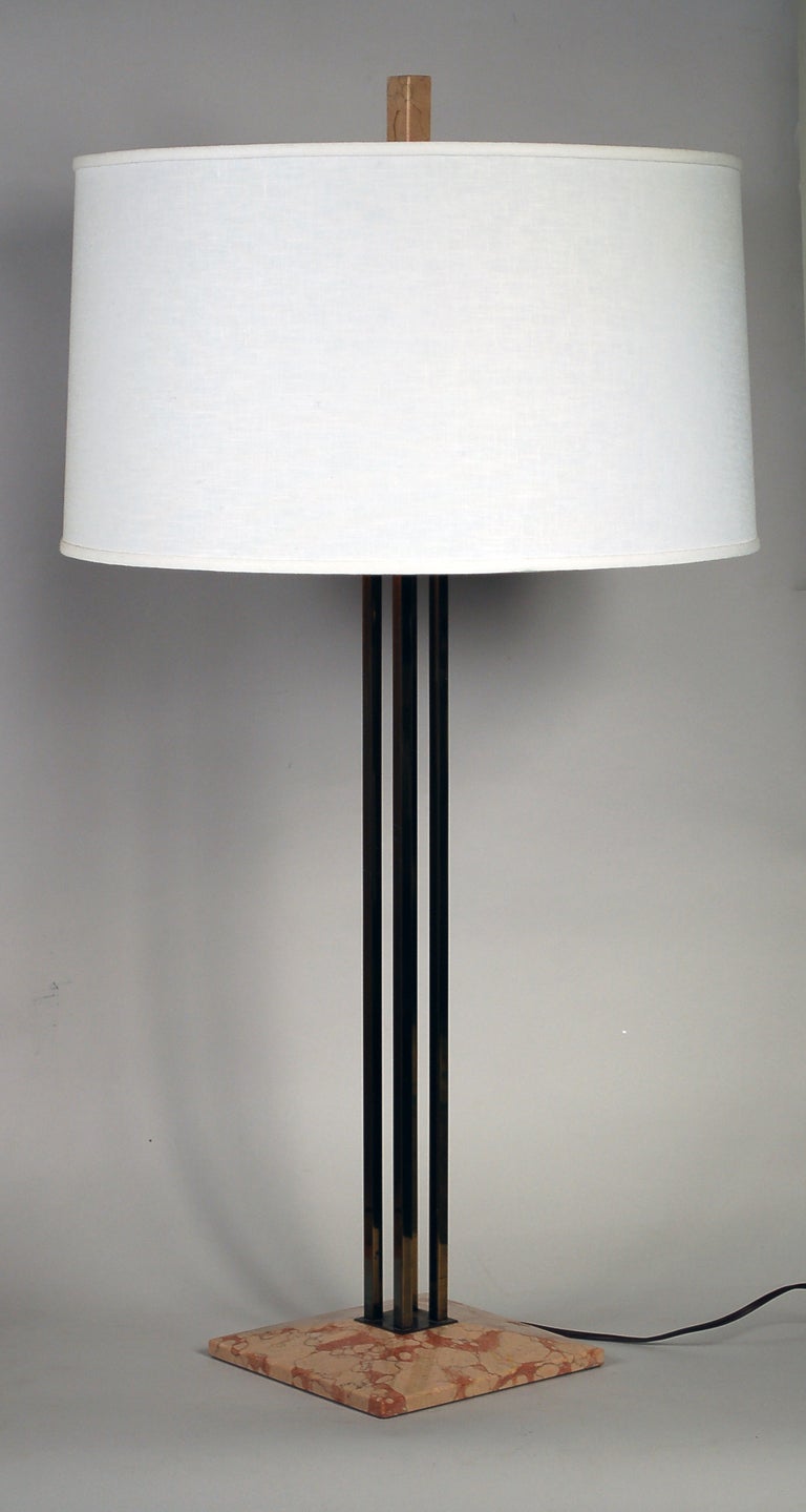 Lightolier table lamp designed by Gerald Thurston. This lamp is comprised of four square brass tubes on a marble base with matching marble finial. There is a perferated metal diffuser on the top of the shade.