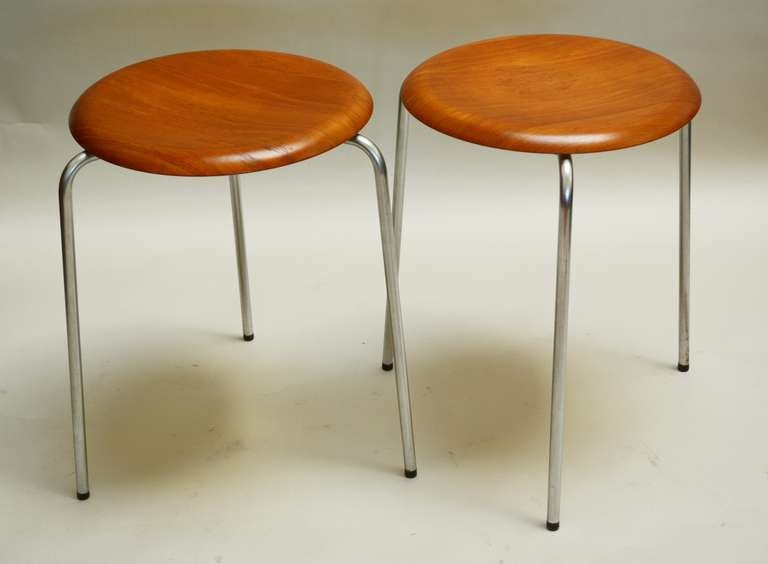 Two earlier dot stools by Arne Jacobsen. These have the original finish with age appropriate wear. The shock mounts holding the base have been replaced on one.