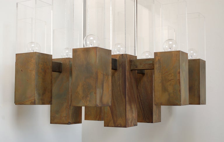 Large bronze and acrylic chandelier by Robert Long. This lamp has 24 lights; 12 up and 12 down. There is a three way switch that lets you light just the top or bottom or both combined. The length of this chandelier can be increased by adding more