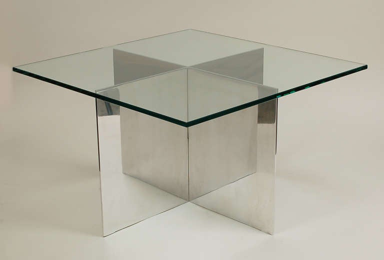 Tables designed by Paul Mayen for Habitat. The table has intersecting plates of polished aluminum to create an "x" form base. One only available.