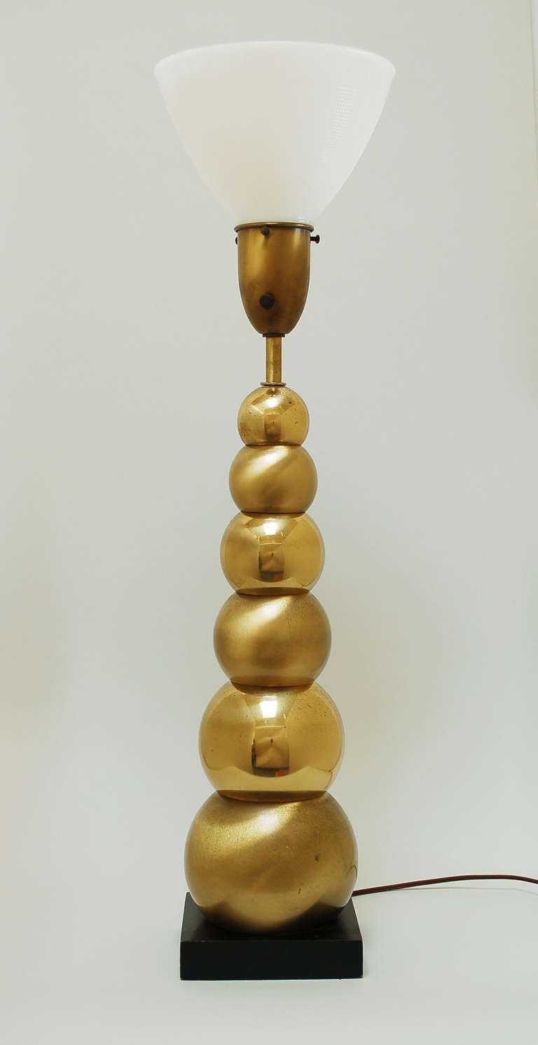 Tapering stacked brass ball table lamp. The finish on the balls alternates between polished and brushed.  Can be had with or with out the original splatter finish shade. The shade is 18