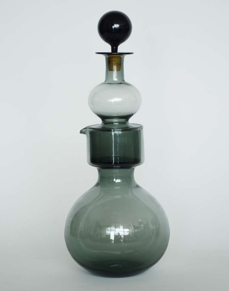 Decanter designed by Kaj Franck for Nuutajarvi Notjso. All three pieces of this are a smoke color. This is signed on the bottom and dated '62.