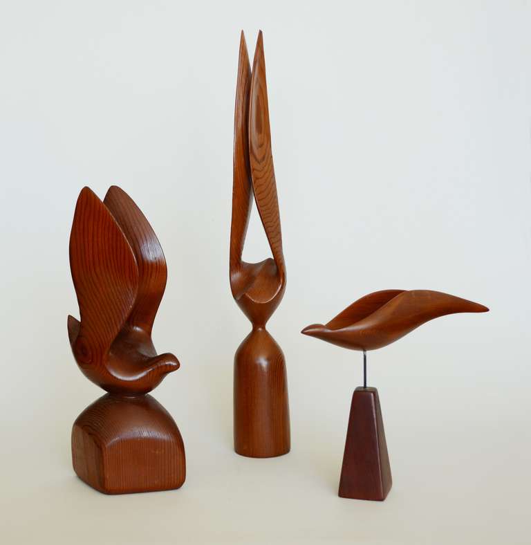 A grouping of three modernist bird sculptures. These were carved by a skilled anonymous craftsman. The sculptures are craved from redwood. They are 16 1/4", 10 1/2" and 7" tall.