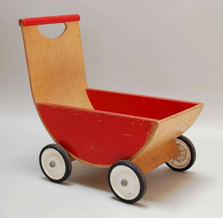 Molded plywood carriage by Creative Playthings. This appeared in the 1967 catalog and was probably designed by Gloria Caranica, who designed the better known rocking horse for Creative Playthings.