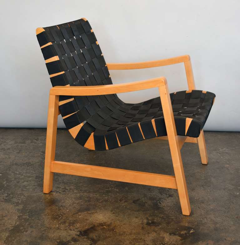 Birch and webbing lounge chair designed by Jens Risom for Knoll. This chair has had the webbing replaced sometime in the past. The frame has been recently restored. It still shows some of the original patina. This retains the early Knoll label.