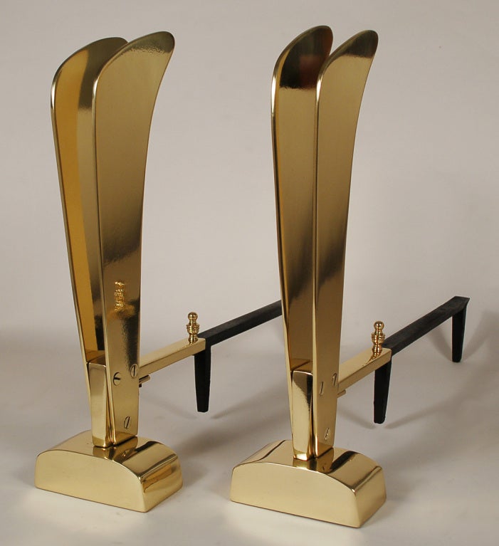 Great modernist andirons reminiscent of stylized boat sails. These are solid brass and have been recently polished and clear coated. Dimensions given are for the brass portions. The overall depth is 21.5