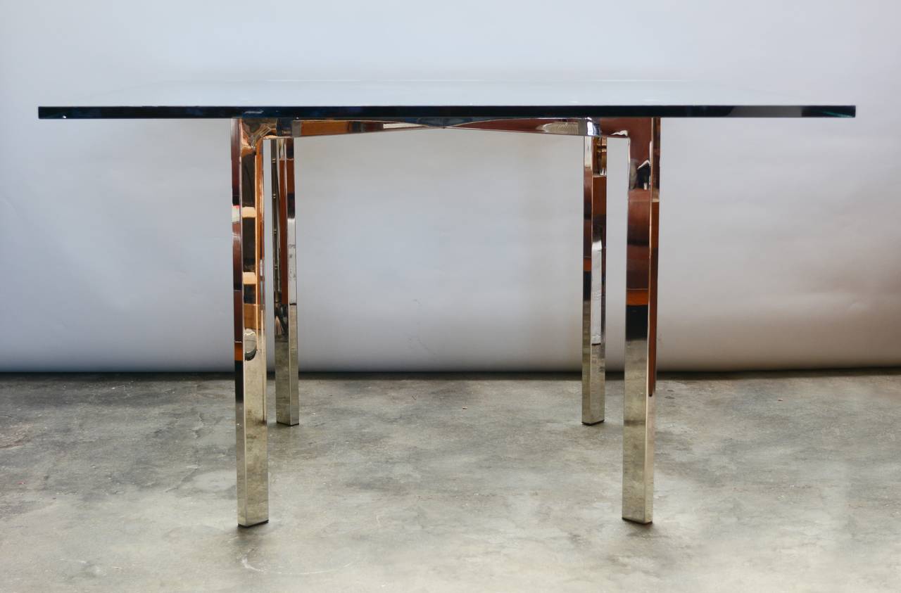 Dinette table reminiscent of the Barcelona table by Le Corbusier. This table has a nickel plated base.