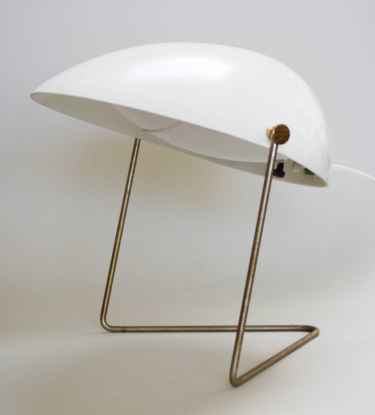 An iconic Gerald Thurston design for Lightolier. The cricket lamp has an adjustable shade and can be hung on a wall as well. The shade of this has been repainted. The metal Stand has some oxidation and wear. The lamp is rewired. The diffuser is a