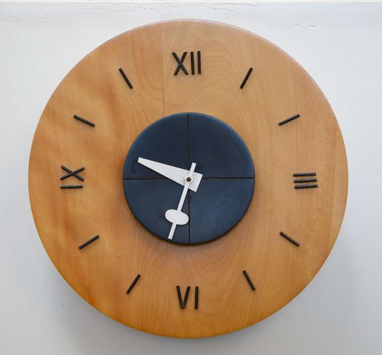 Wall clock designed by the George Nelson office for Howard Miller. This clock is electric and retains a partial original label on the back. The clock is made of birch and the markers are metal. The second hand is missing.