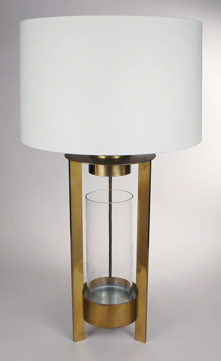 This lamp is the companion to the table often attributed to Dorothy Thorpe. The lamp has a glass display cylinder in the center. There is a small bulb that illuminates the cylinder from above and can be turned on and off separate of the main