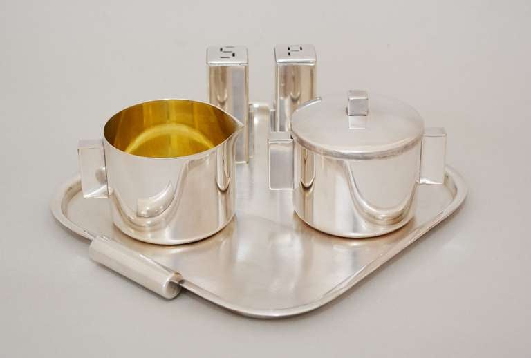 Streamline moderne cream and sugar set by Merle F. Faber of San Francisco. This set includes a tray and a skyscraper style salt and pepper. These where made between 1943 and 1950. All pieces are marked Merle F. Faber Products S.F. Quadruple plate.