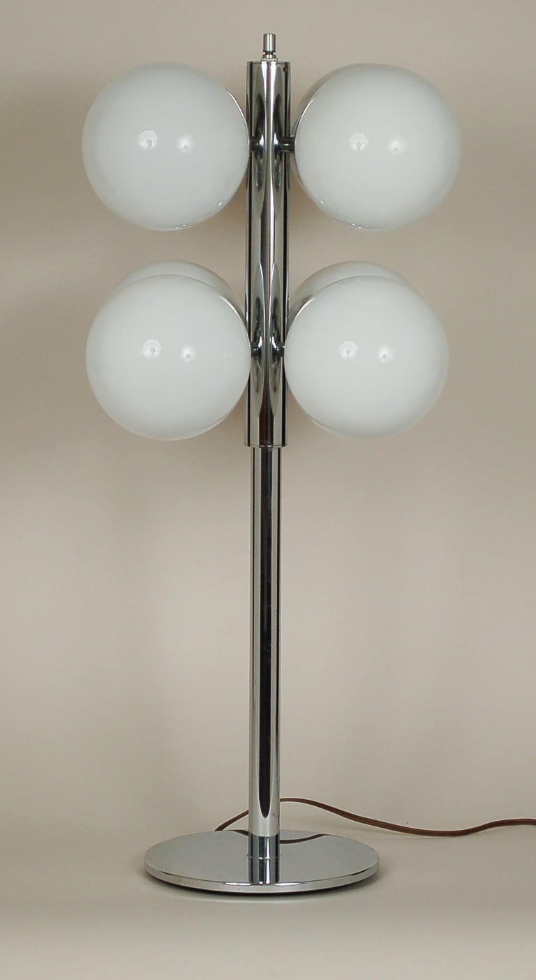 Lightolier chrome table lamp with eight glass globes. The switch on the top of this lamp acts as a dimmer as well.

 