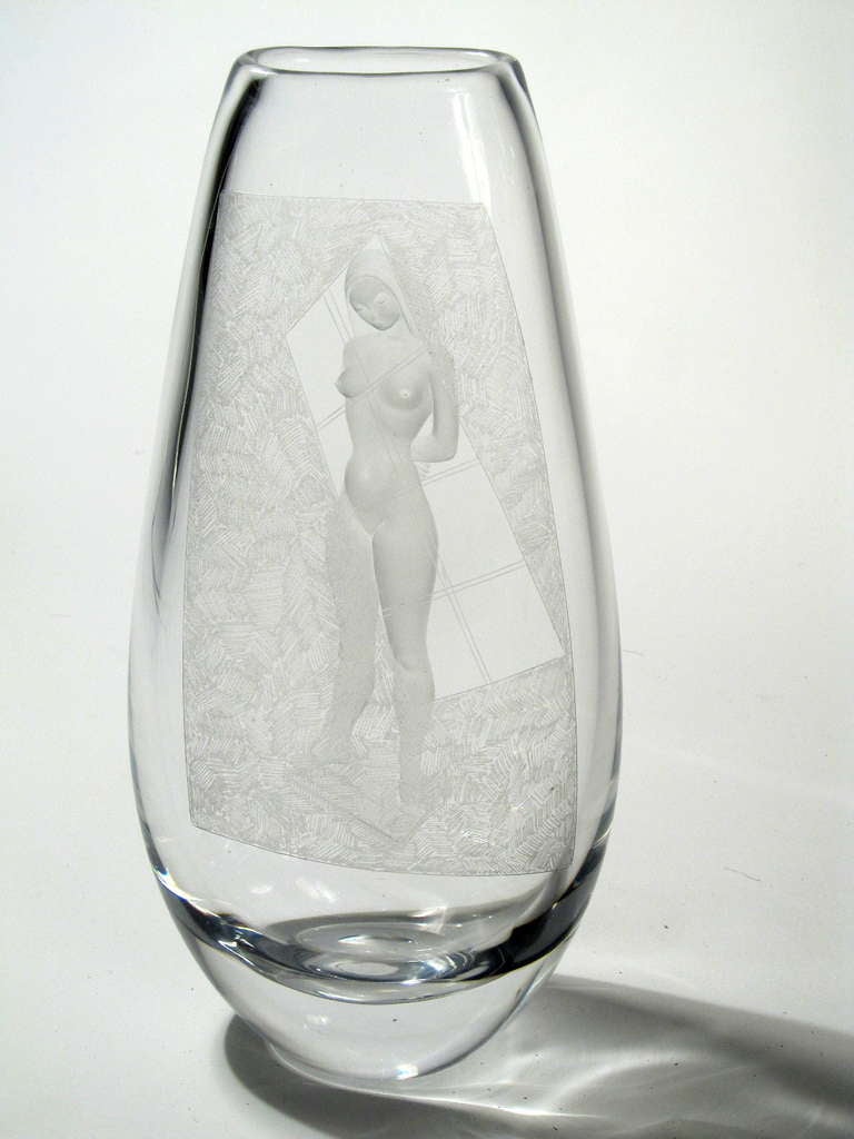 This is an exceptional Vicke Lindstrand vase for Kosta in Sweden. On one side is a textured wall with an eschew window left clear. On the opposite side is a nude female, unaware that she is being observed. The execution and effect is stunning.