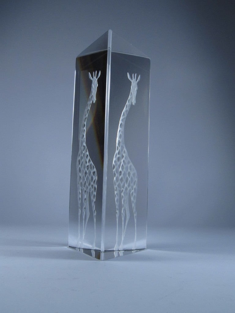Made from a large three sided prism of fine Kosta crystal, with a single giraffe etched on one side.  The single image is reflected around the surfaces, and 2 images are usually visible.