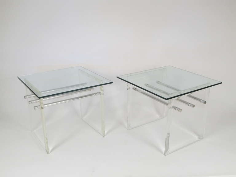 Very Minimalist and clean, these tables have a presence all their own. The two beveled sides are Lucite and the three aluminum rods which are the stretchers that connect them, are threaded on at both ends, giving the construction rigidity. The tops